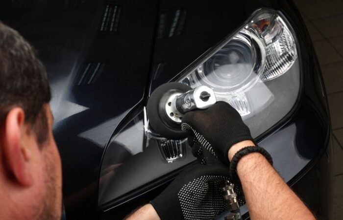 Professional technician restoring cloudy, yellowed car headlights to improve nighttime visibility and driving safety in Toms River, NJ.