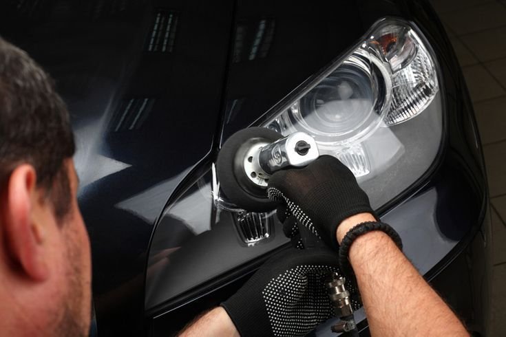 Professional technician restoring cloudy, yellowed car headlights to improve nighttime visibility and driving safety in Toms River, NJ.
